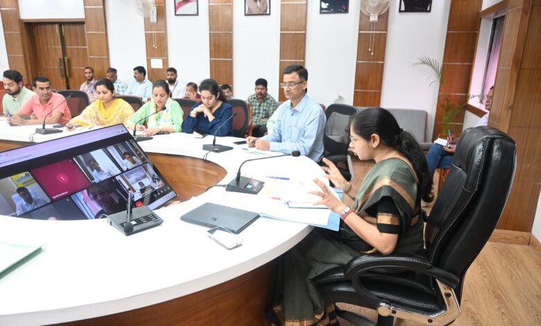 District Magistrate of Tehri reviewing GIS land bank plans in a meeting